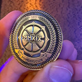 Original Founders Club challenge coin held in hand, with MMXIX and Founders Club design.