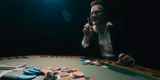 Mystery Jackpot 2026 poker-table scene with a raised-finger gesture.